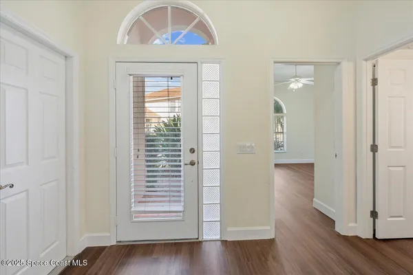 a view of an entryway with wooden floor