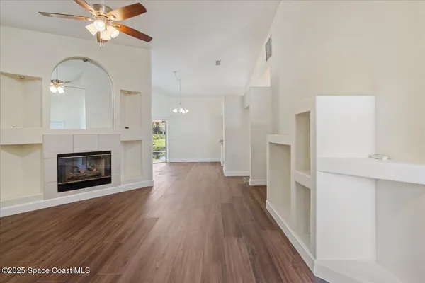 a view of a livingroom with wooden floor a fireplace