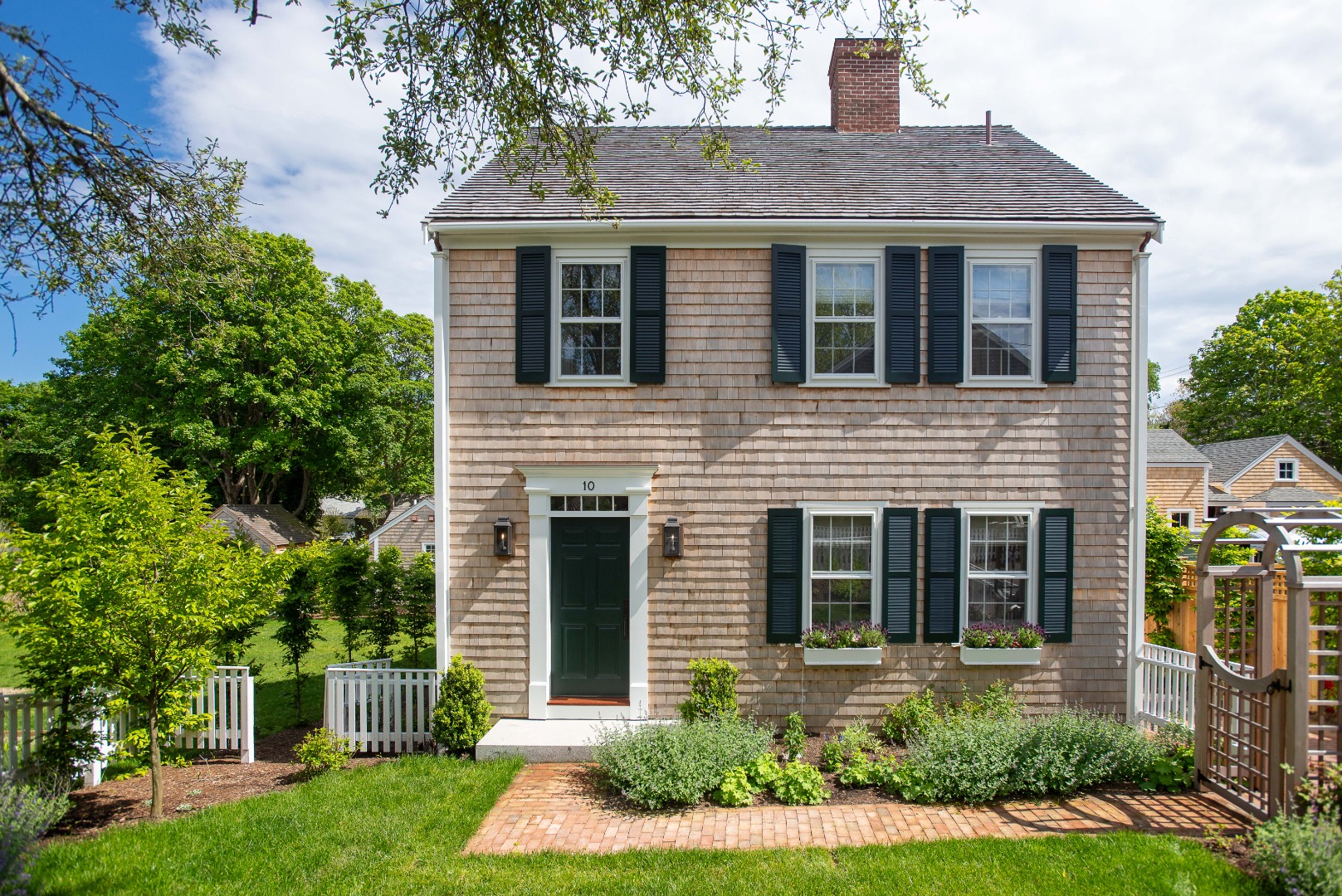 10 Silver Street Nantucket, MA 02554 - Photo 1 of 48 a front view of a house with a yard and porch