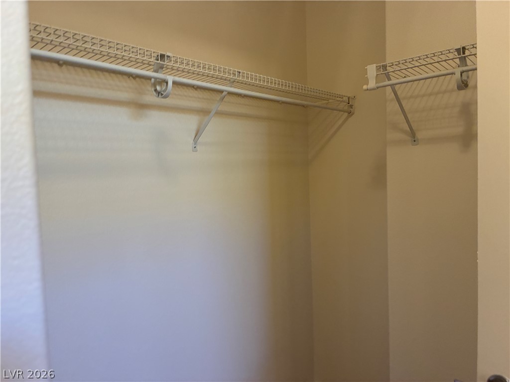 Ample wire shelving provides practical storage solutions within this well-appointed closet space.