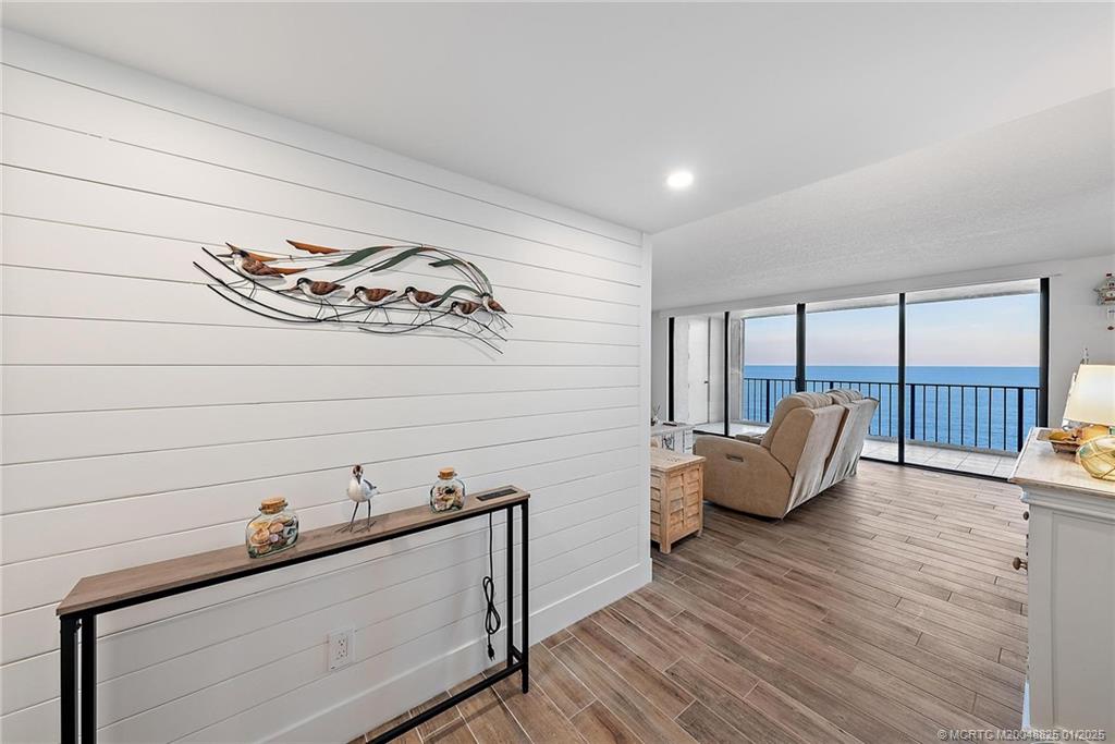 8750 South Ocean Drive, Unit 1435 Jensen Beach, FL 34957 - Photo 16 of 38 a living room with furniture and wooden floor