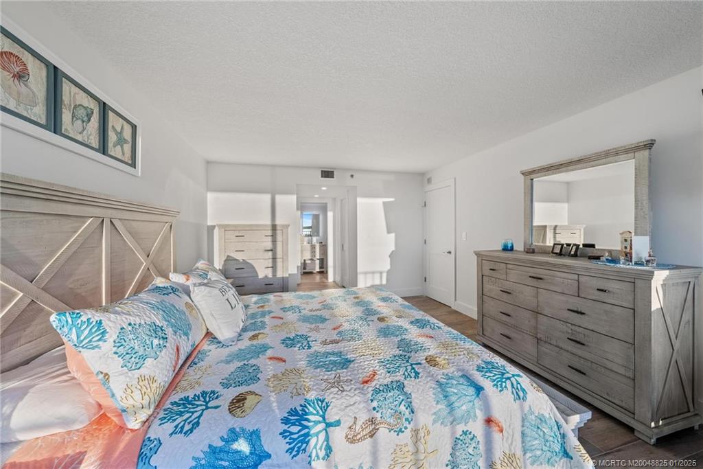 8750 South Ocean Drive, Unit 1435 Jensen Beach, FL 34957 - Photo 19 of 38 a bedroom with a bed and a mirror on dresser