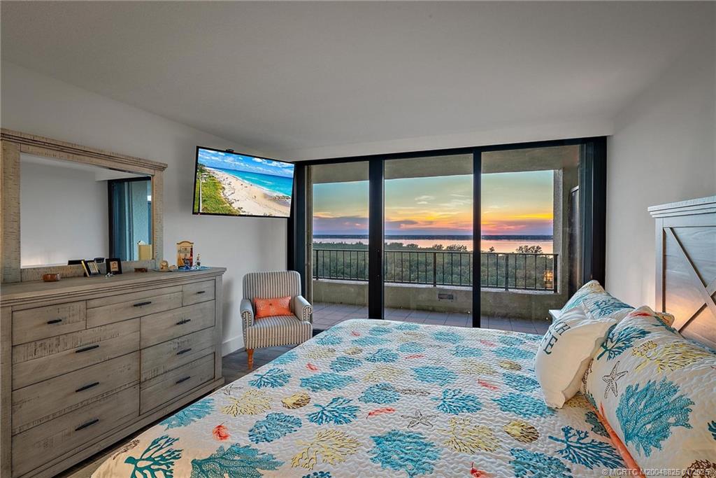 8750 South Ocean Drive, Unit 1435 Jensen Beach, FL 34957 - Photo 22 of 38 a bed room with a bed and a large window