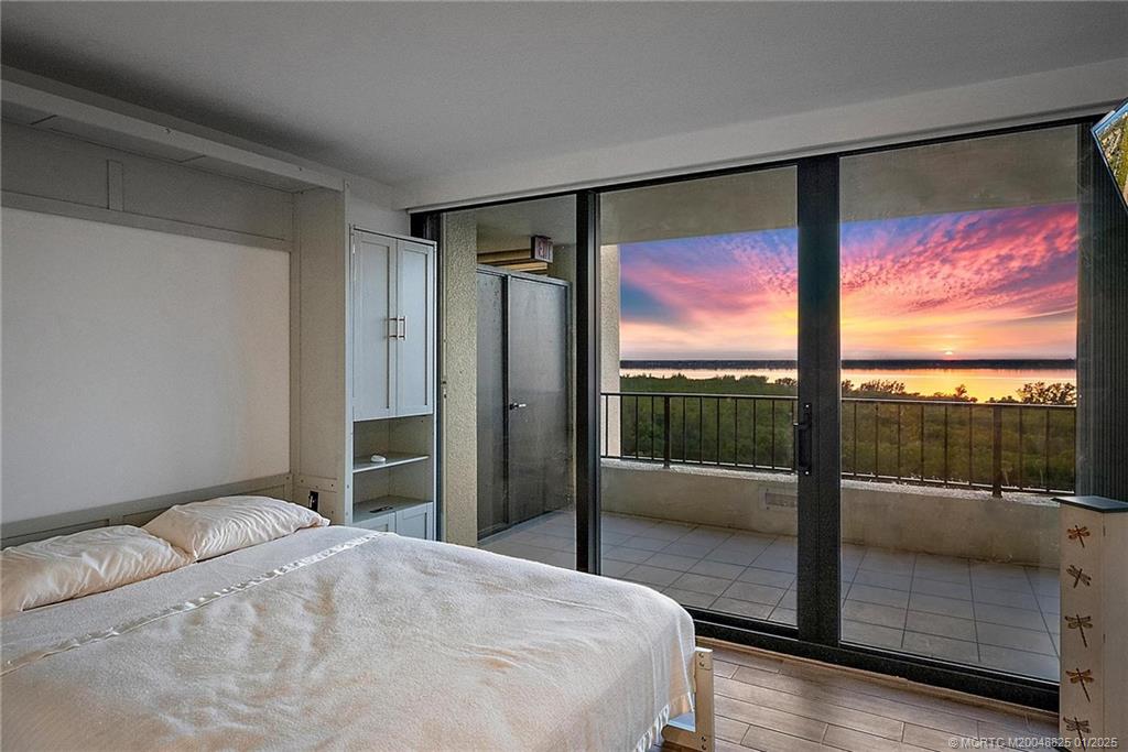 8750 South Ocean Drive, Unit 1435 Jensen Beach, FL 34957 - Photo 26 of 38 a bedroom with a balcony and large window