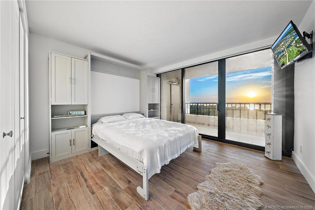 8750 South Ocean Drive, Unit 1435 Jensen Beach, FL 34957 - Photo 27 of 38 a spacious bedroom with a bed and a large window