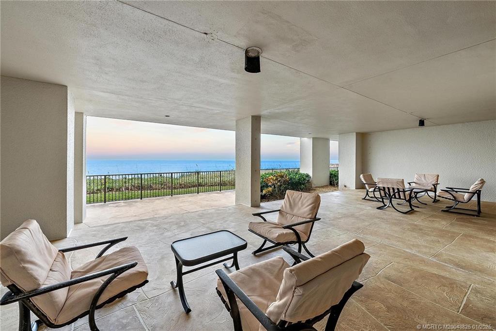 8750 South Ocean Drive, Unit 1435 Jensen Beach, FL 34957 - Photo 31 of 38 a living room with furniture and a floor to ceiling window