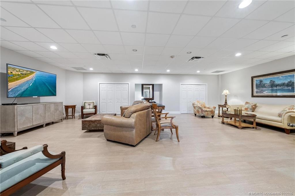 8750 South Ocean Drive, Unit 1435 Jensen Beach, FL 34957 - Photo 35 of 38 a living room with furniture and a flat screen tv