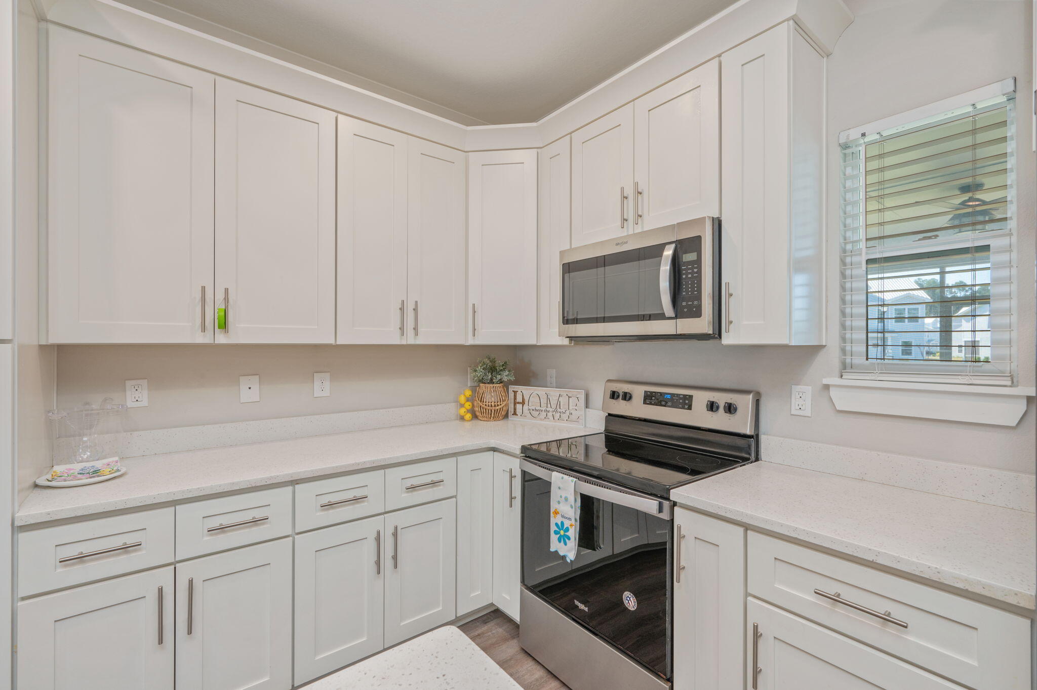 275 North Sand Palm Road, Unit 167VISTA Freeport, FL 32439 - Photo 11 of 40 a kitchen with white cabinets and white appliances