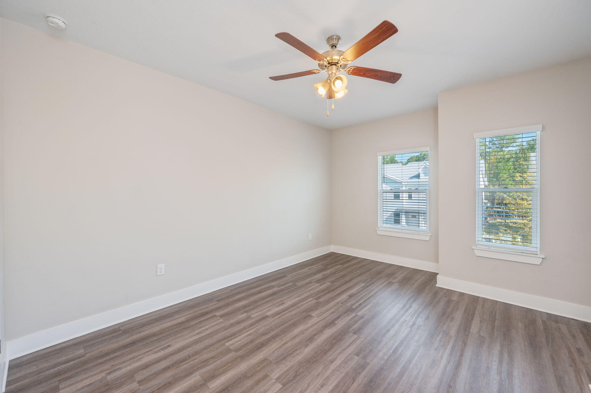 275 North Sand Palm Road, Unit 167VISTA Freeport, FL 32439 - Photo 17 of 40 an empty room with wooden floor and windows