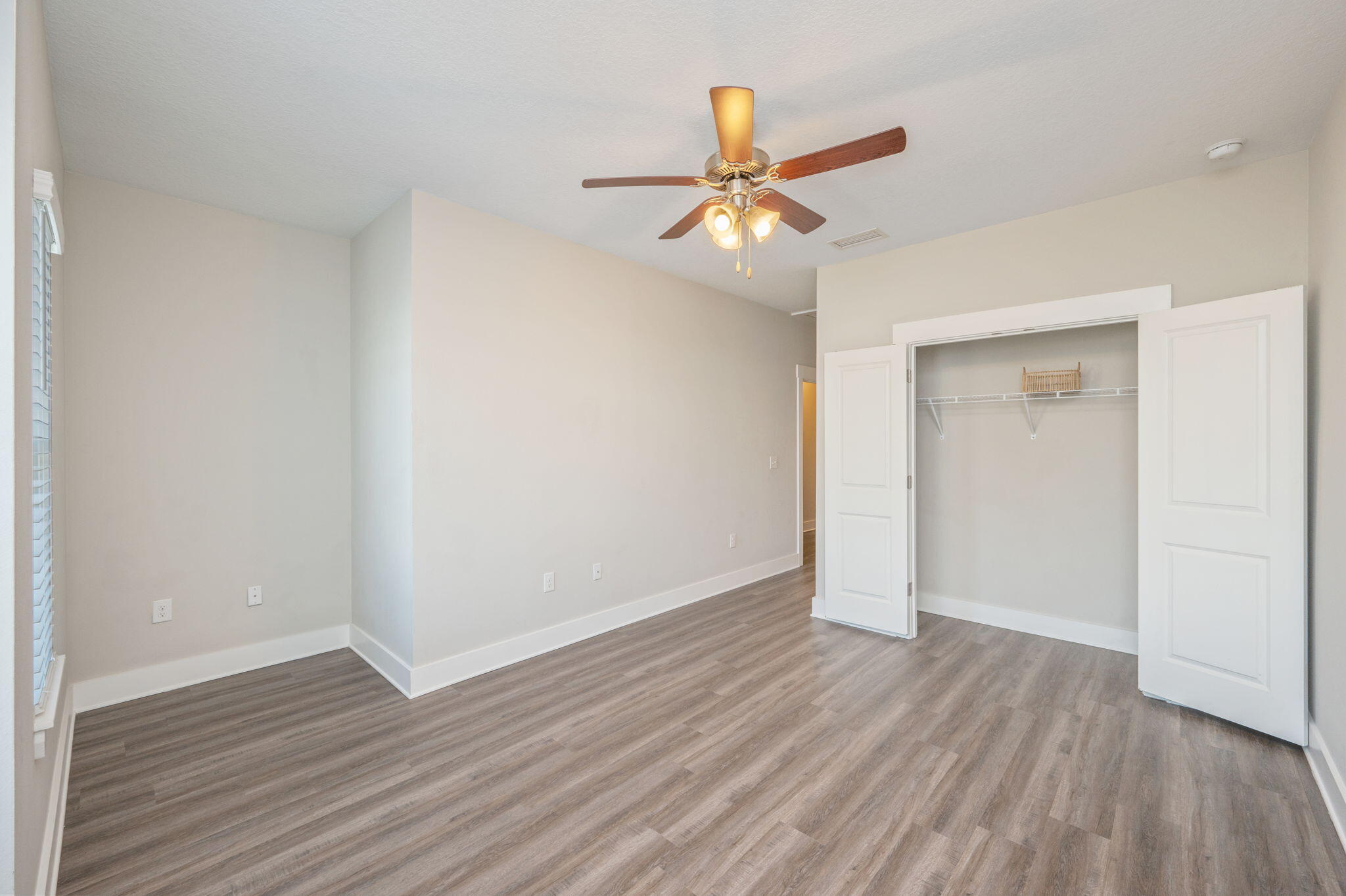 275 North Sand Palm Road, Unit 167VISTA Freeport, FL 32439 - Photo 19 of 40 an empty room with wooden floor fan and windows