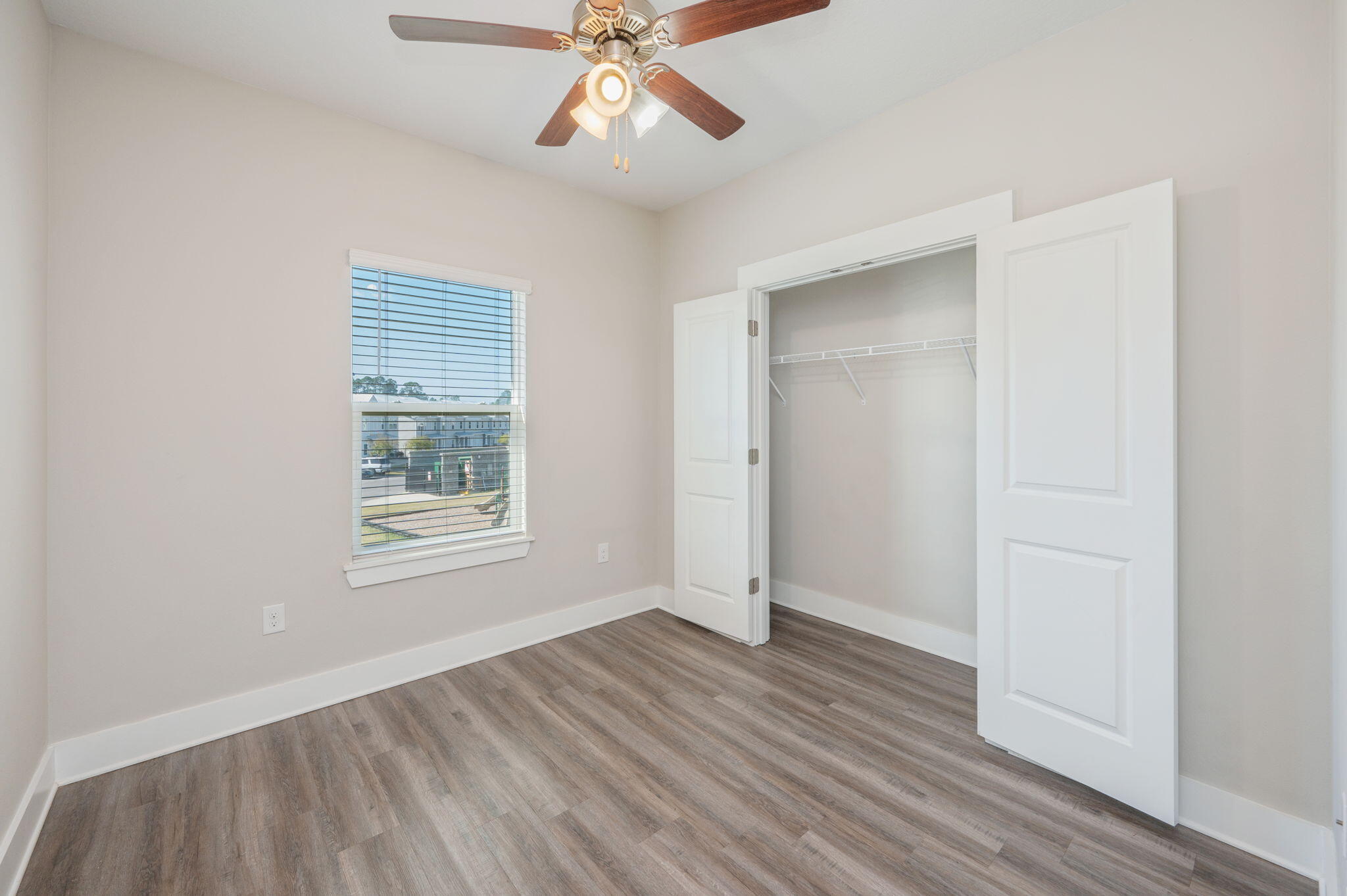 275 North Sand Palm Road, Unit 167VISTA Freeport, FL 32439 - Photo 24 of 40 a view of an empty room with wooden floor and a window