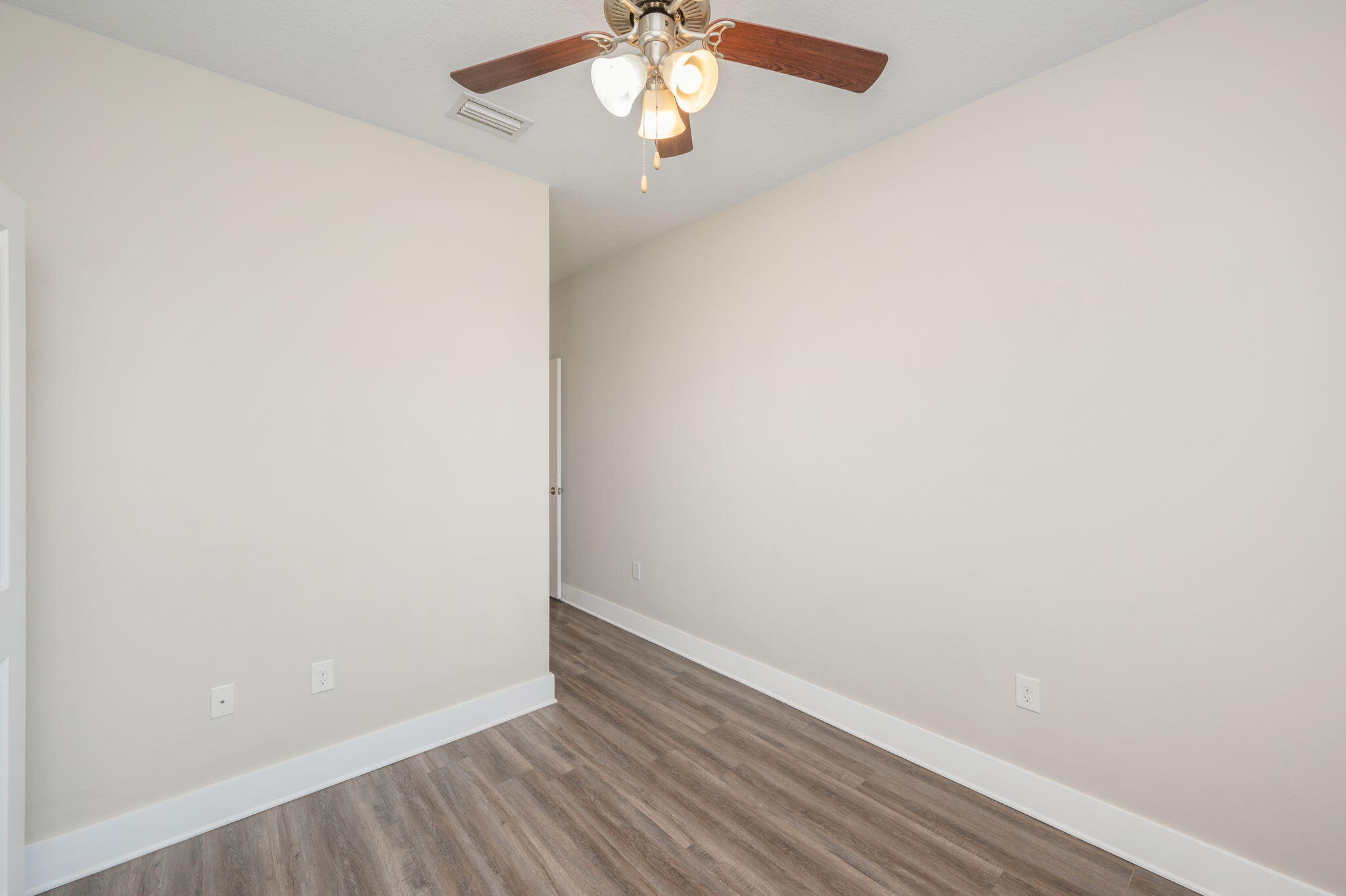 275 North Sand Palm Road, Unit 167VISTA Freeport, FL 32439 - Photo 25 of 40 a view of an empty room with wooden floor