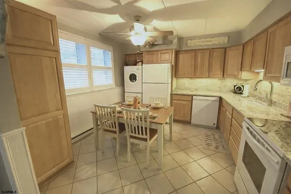 a kitchen with a sink a table and chairs
