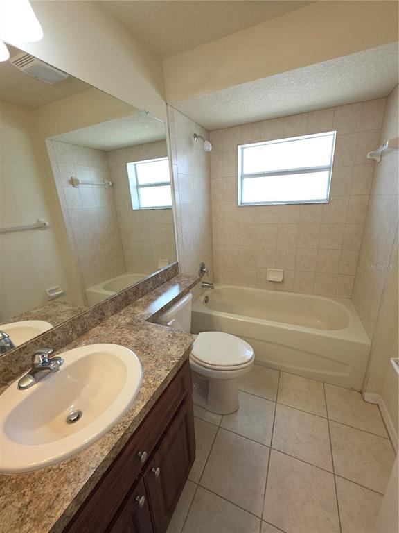 4284 High Ridge Avenue Spring Hill, FL 34609 - Photo 17 of 40 a bathroom with a granite countertop sink toilet and shower