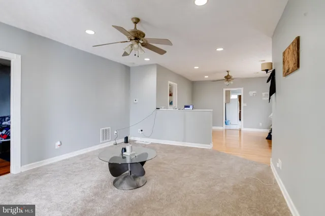 a view of a workspace with furniture and wooden floor