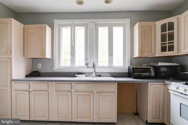 a kitchen with a sink cabinets and appliances