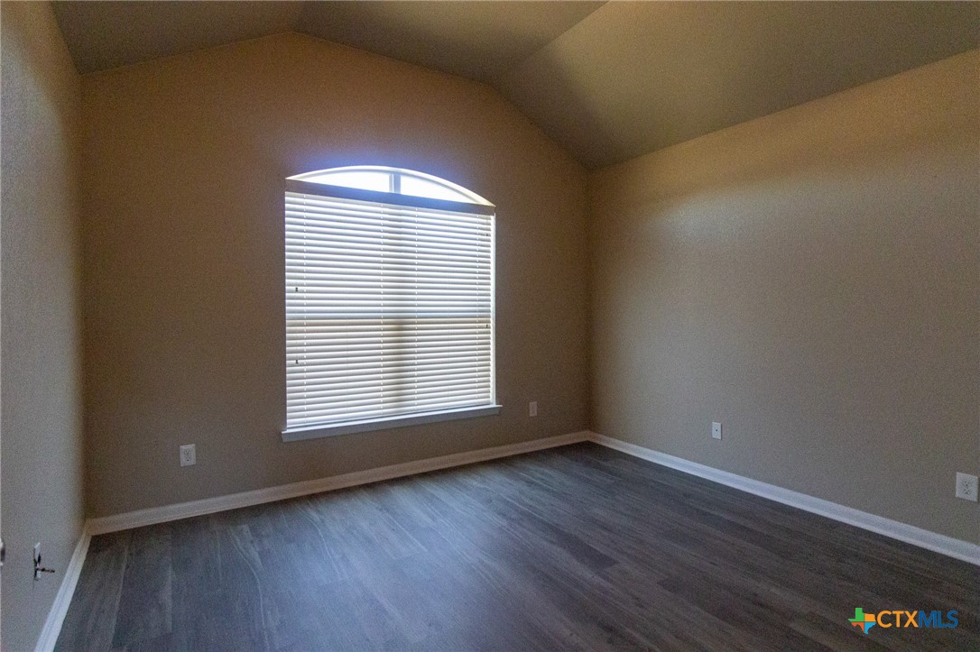 217 Pointer Street Nolanville, TX 76559 - Photo 25 of 29 an empty room with wooden floor and windows
