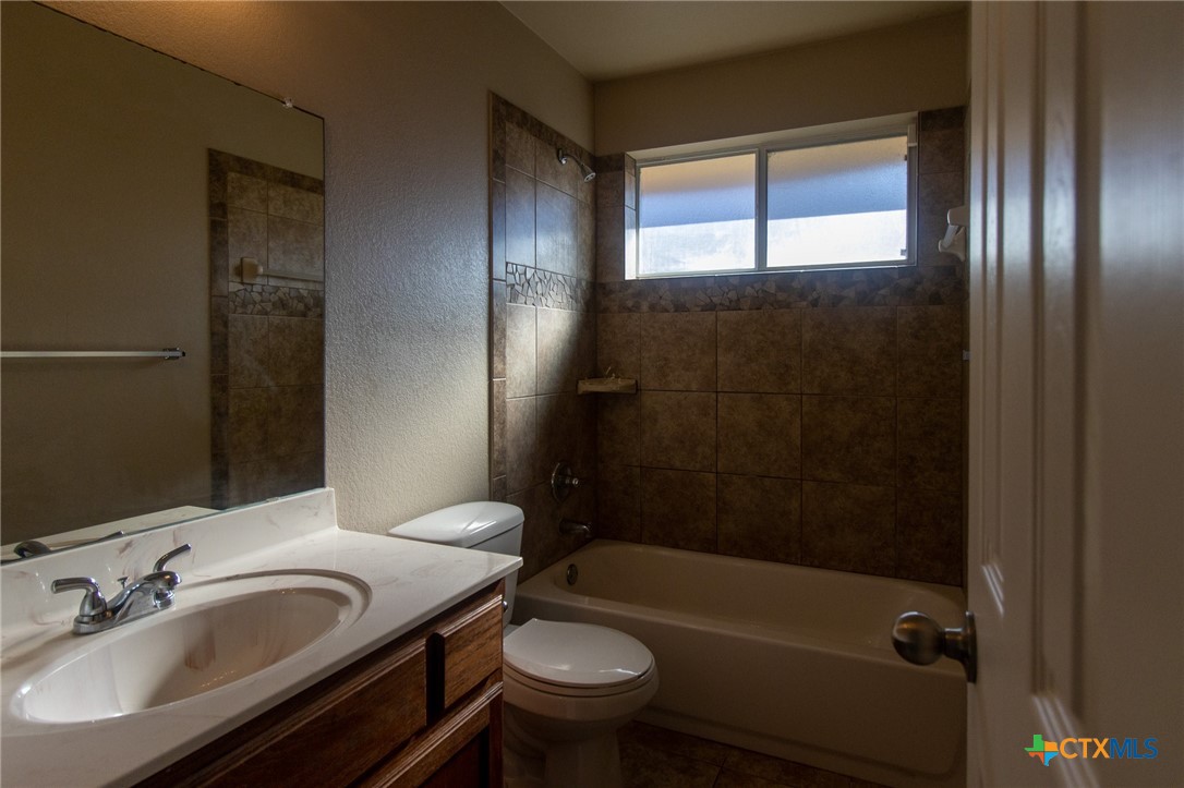 217 Pointer Street Nolanville, TX 76559 - Photo 27 of 29 a bathroom with a sink toilet and shower