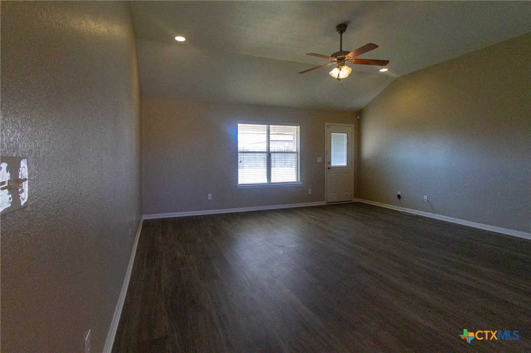 217 Pointer Street Nolanville, TX 76559 - Photo 4 of 29 an empty room with wooden floor and windows