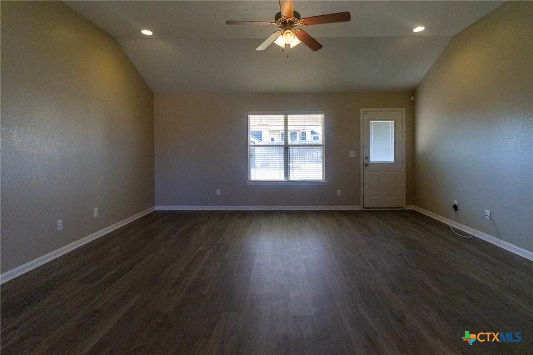 217 Pointer Street Nolanville, TX 76559 - Photo 5 of 29 an empty room with wooden floor and windows