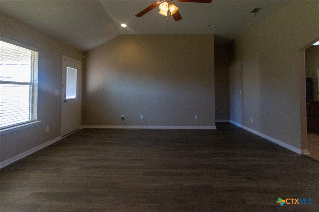 217 Pointer Street Nolanville, TX 76559 - Photo 6 of 29 an empty room with wooden floor and windows