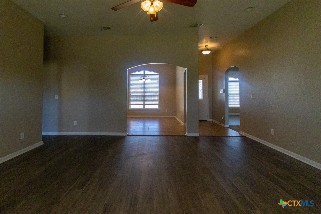 217 Pointer Street Nolanville, TX 76559 - Photo 7 of 29 an empty room with wooden floor and windows