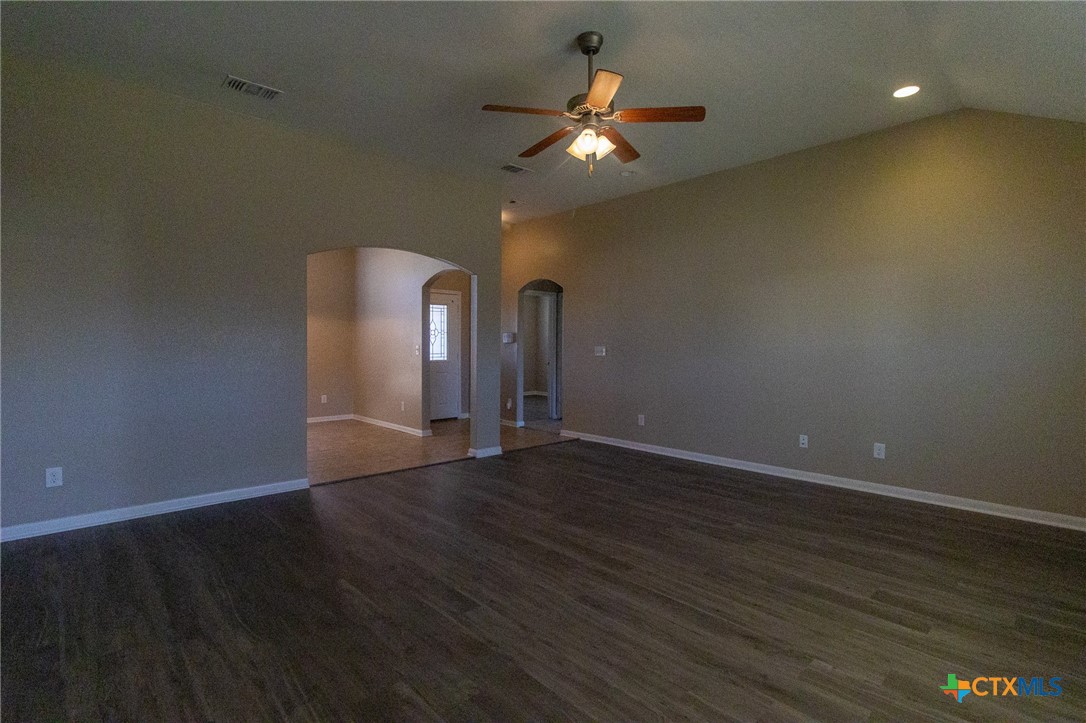 217 Pointer Street Nolanville, TX 76559 - Photo 8 of 29 a view of an empty room with wooden floor and a window
