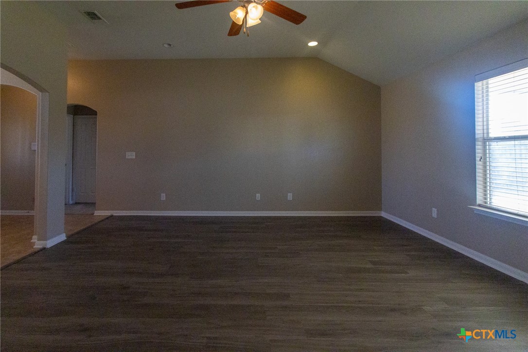 217 Pointer Street Nolanville, TX 76559 - Photo 9 of 29 an empty room with wooden floor and windows
