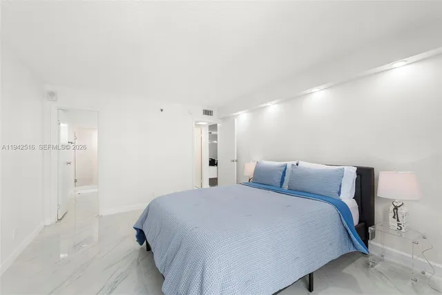 a bedroom with a bed and a lamp