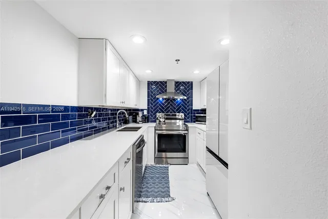 a kitchen with stainless steel appliances a sink and cabinets