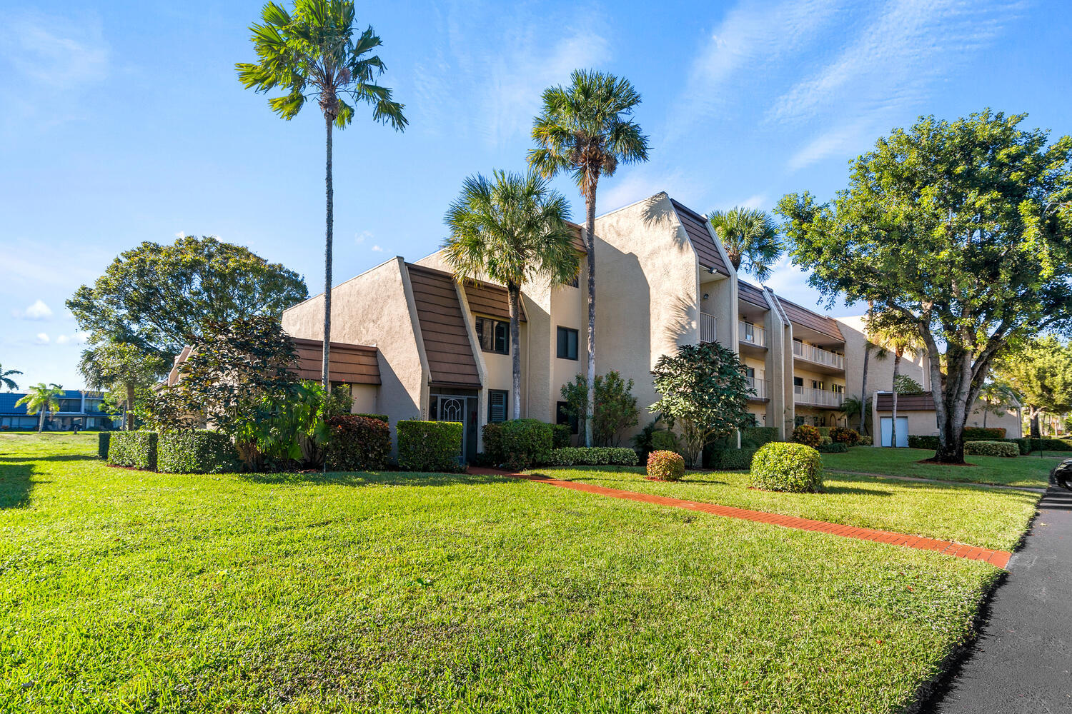 4100 Tivoli Court, Unit 201 Lake Worth, FL 33467 - Photo 1 of 5 a front view of a house with garden