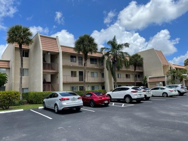 4100 Tivoli Court, Unit 201 Lake Worth, FL 33467 - Photo 2 of 5 a car parked in front of a building