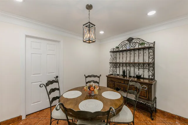 a view of a dining room with furniture wooden floor and chandelier