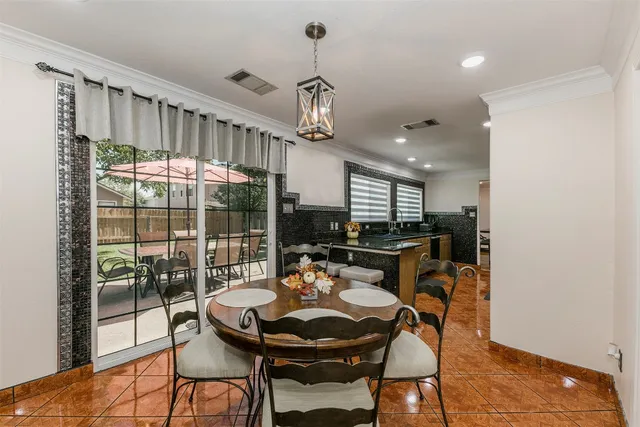 a dining room with furniture a chandelier and wooden floor