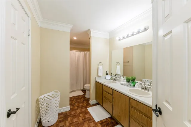 a spacious bathroom with a double vanity sink and a mirror