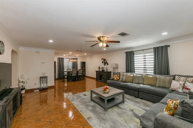 a living room with furniture and wooden floor