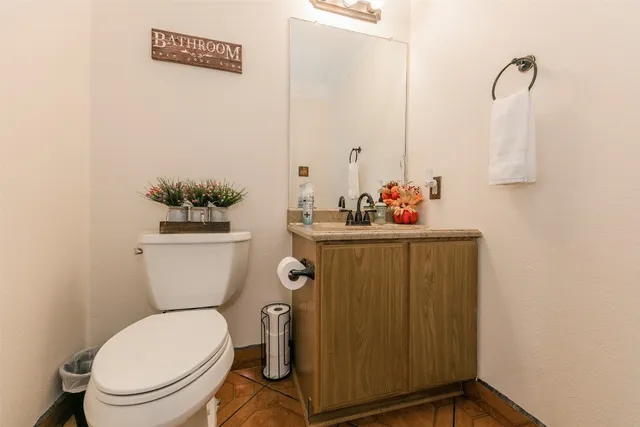 a bathroom with a toilet sink and mirror