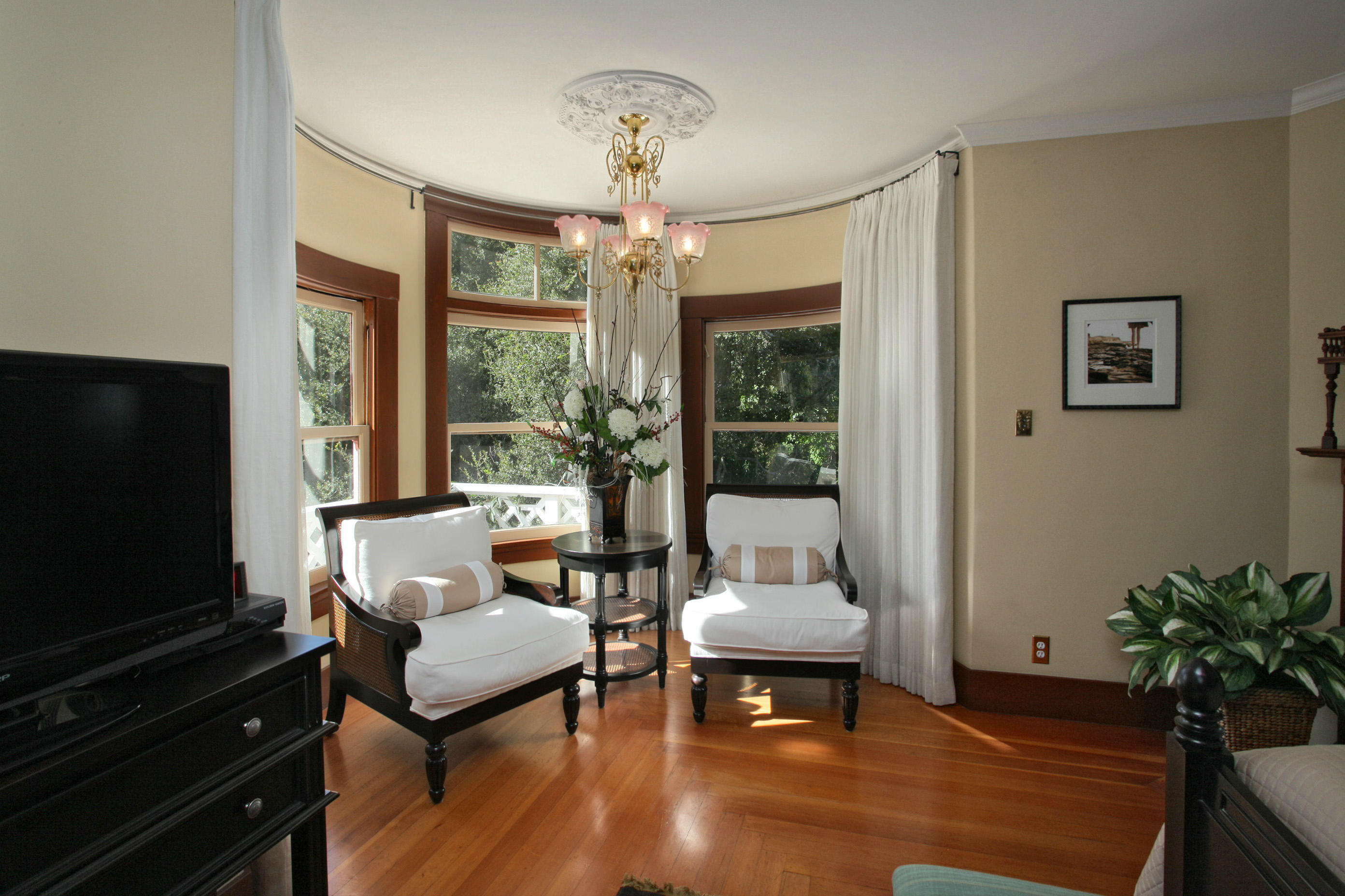 60 Olive Mill Road Santa Barbara, CA 93108 - Photo 13 of 15 a living room with furniture a flat screen tv and a floor to ceiling window
