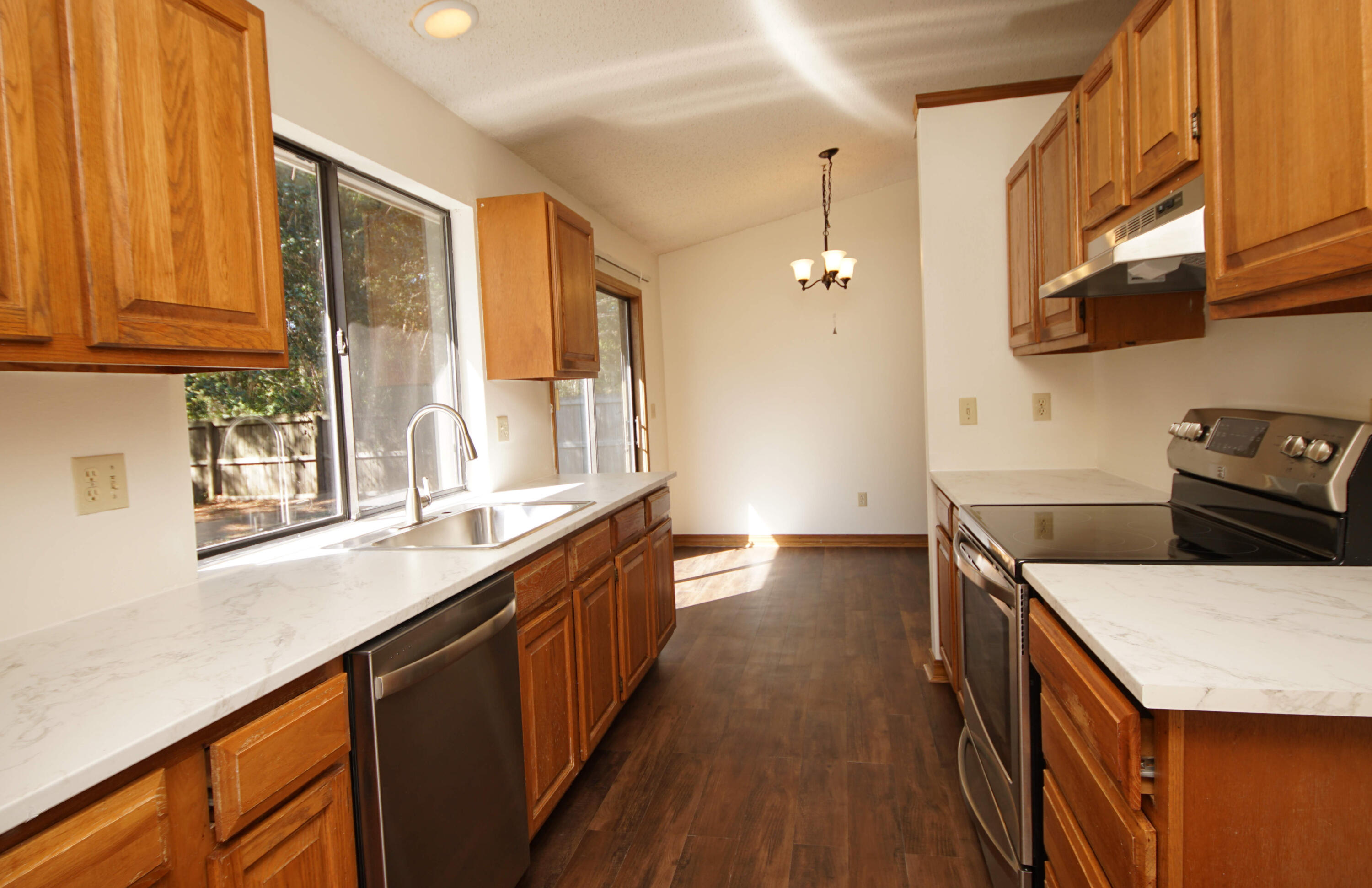 912 Nutmeg Avenue Niceville, FL 32578 - Photo 12 of 30 a kitchen with stainless steel appliances sink stove and cabinets
