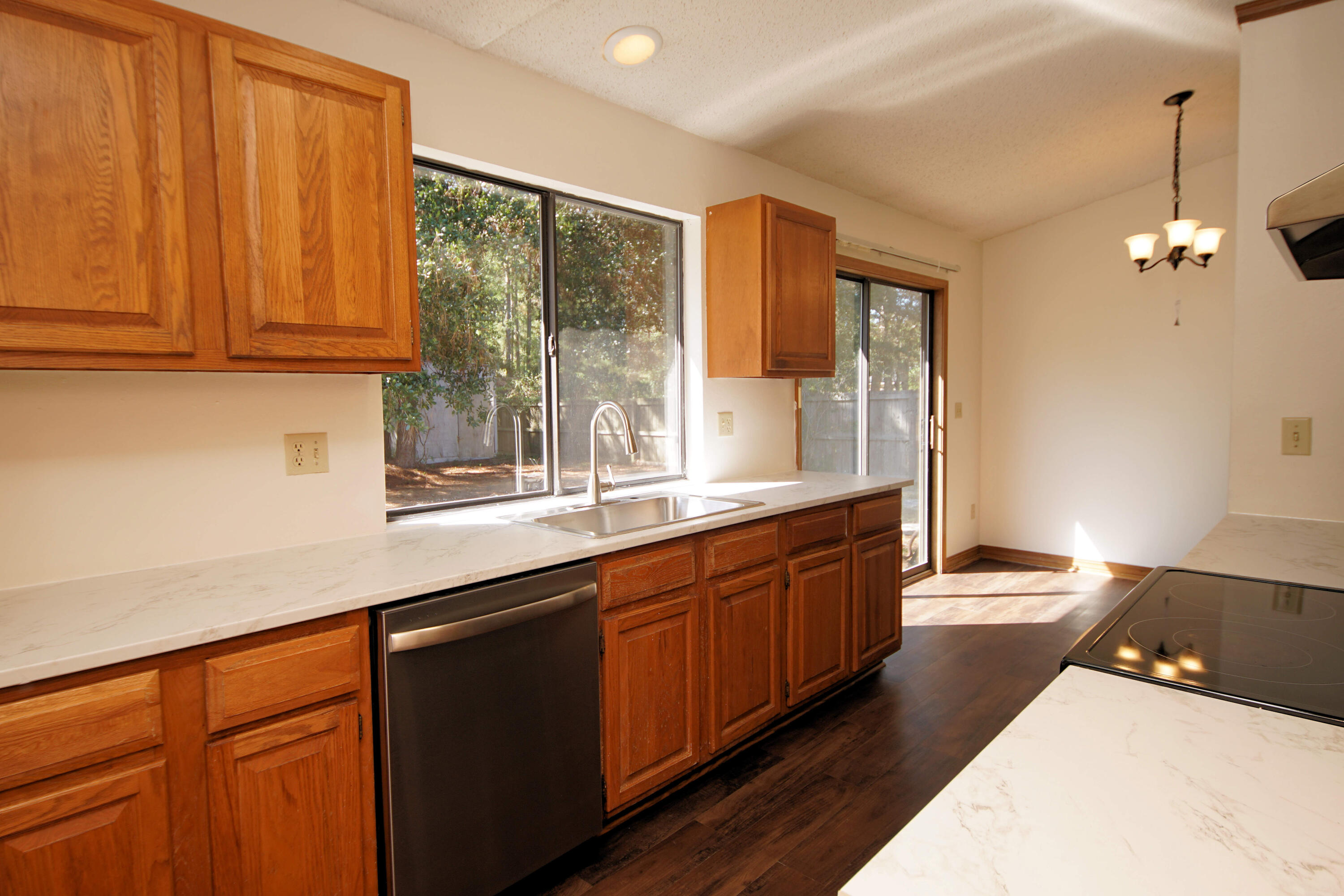 912 Nutmeg Avenue Niceville, FL 32578 - Photo 14 of 30 a large kitchen with granite countertop a sink stainless steel appliances and cabinets