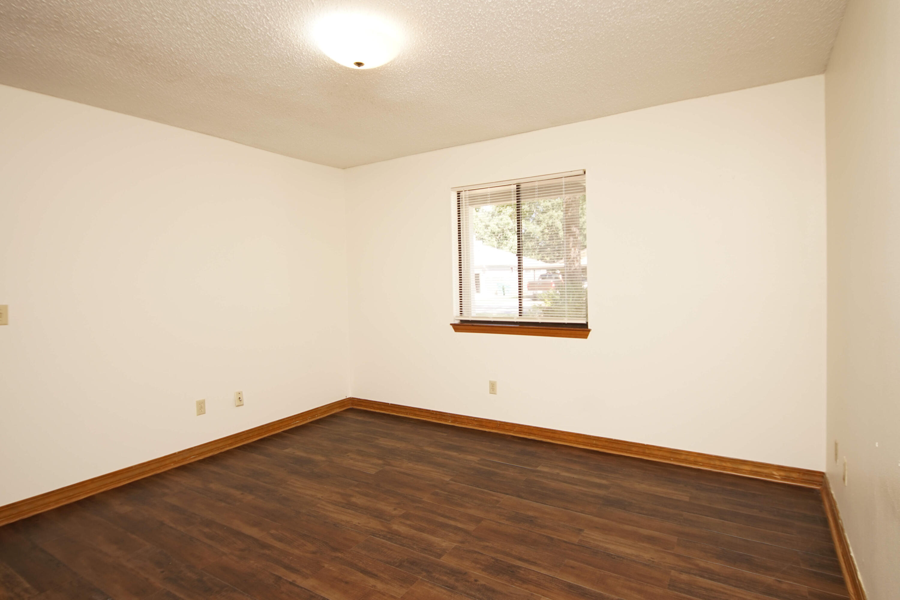 912 Nutmeg Avenue Niceville, FL 32578 - Photo 15 of 30 an empty room with wooden floor and windows