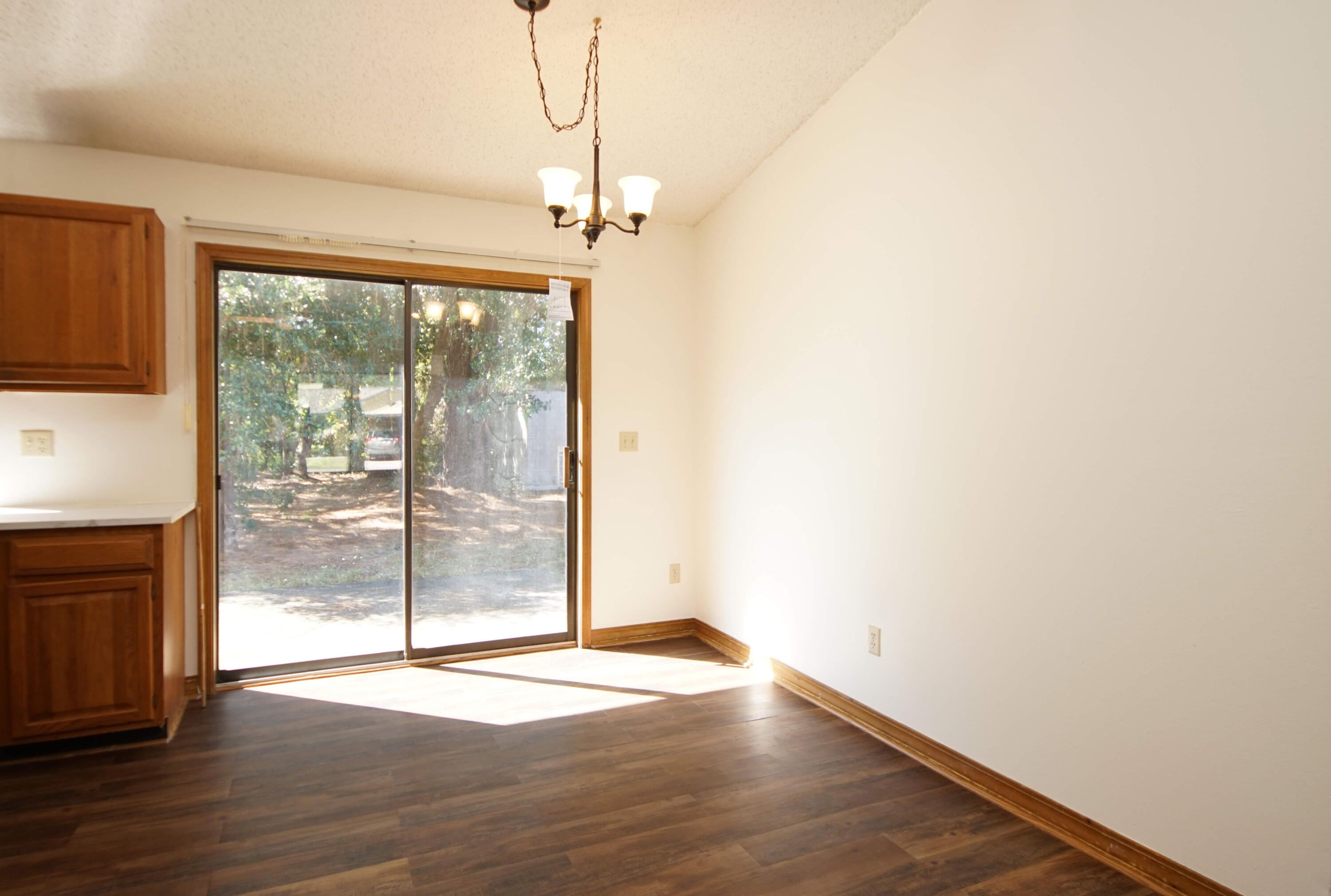 912 Nutmeg Avenue Niceville, FL 32578 - Photo 17 of 30 a view of empty room with wooden floor and fan