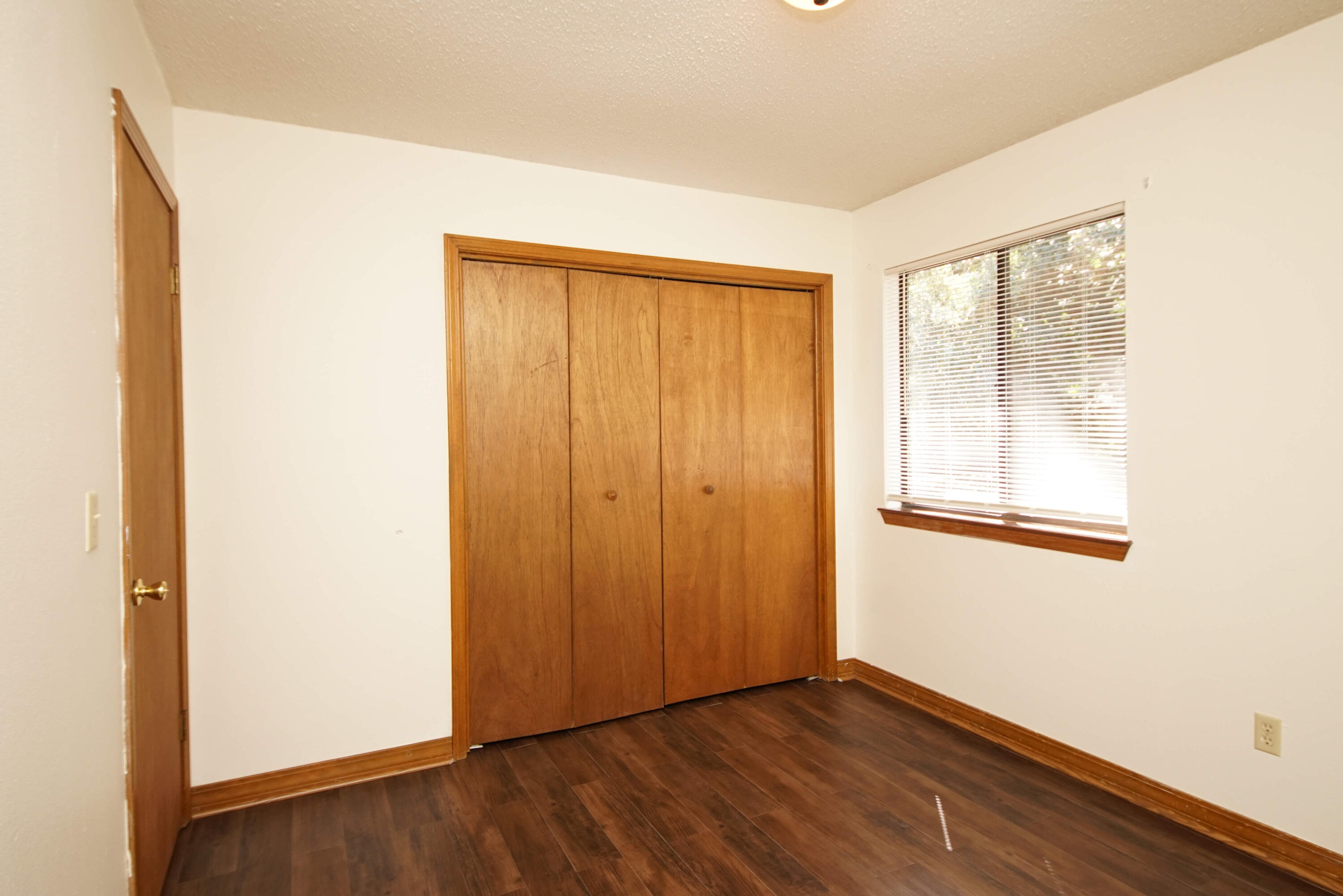 912 Nutmeg Avenue Niceville, FL 32578 - Photo 20 of 30 a view of an empty room with wooden floor and a window