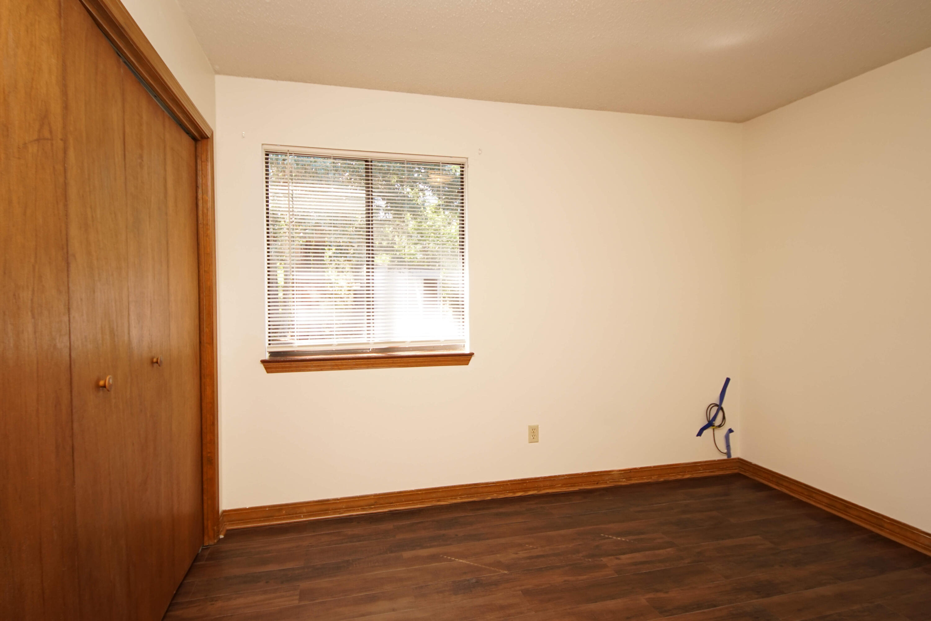 912 Nutmeg Avenue Niceville, FL 32578 - Photo 21 of 30 an empty room with wooden floor and windows