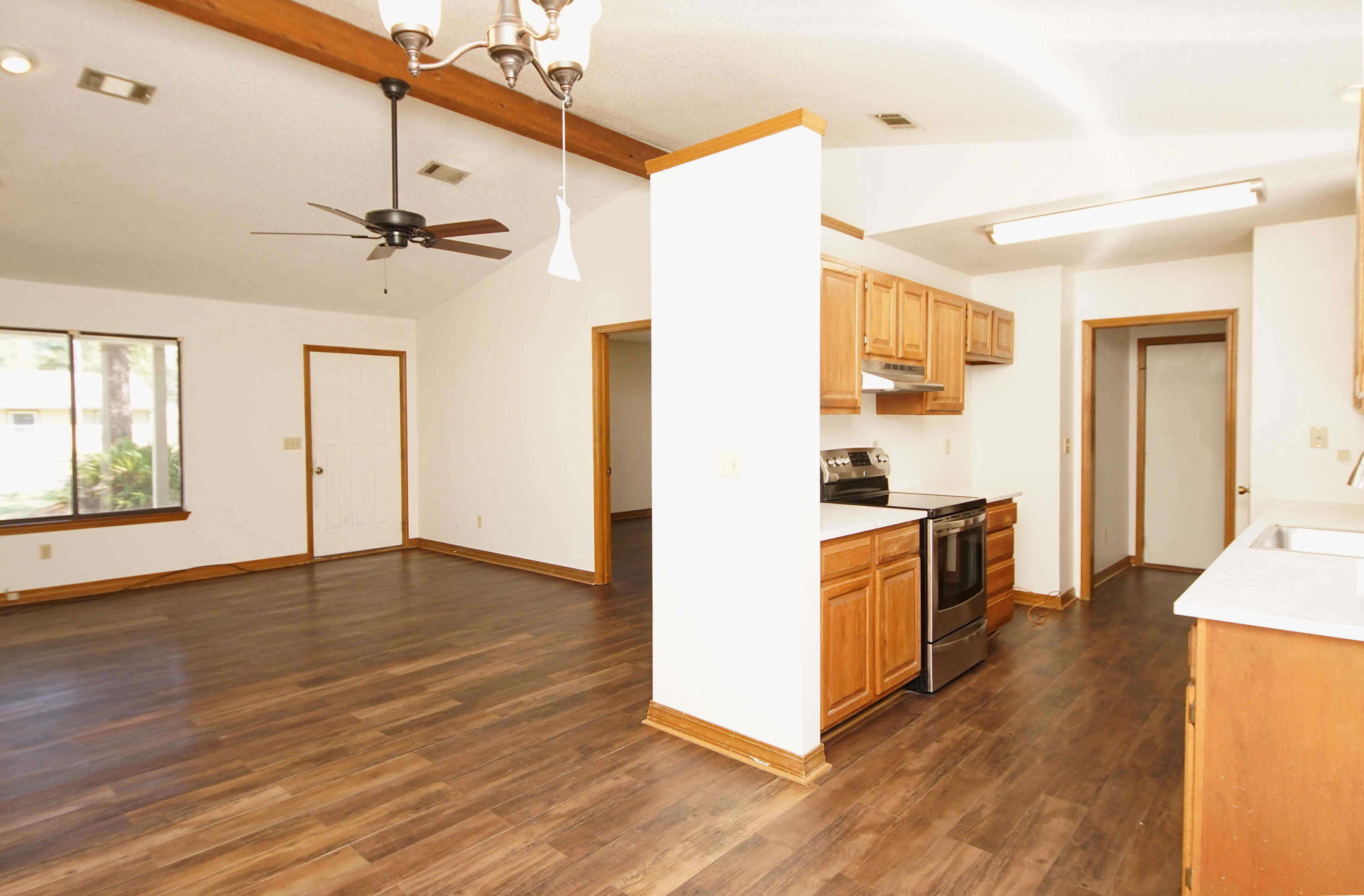 912 Nutmeg Avenue Niceville, FL 32578 - Photo 5 of 30 a kitchen with stainless steel appliances granite countertop a sink cabinets and wooden floor