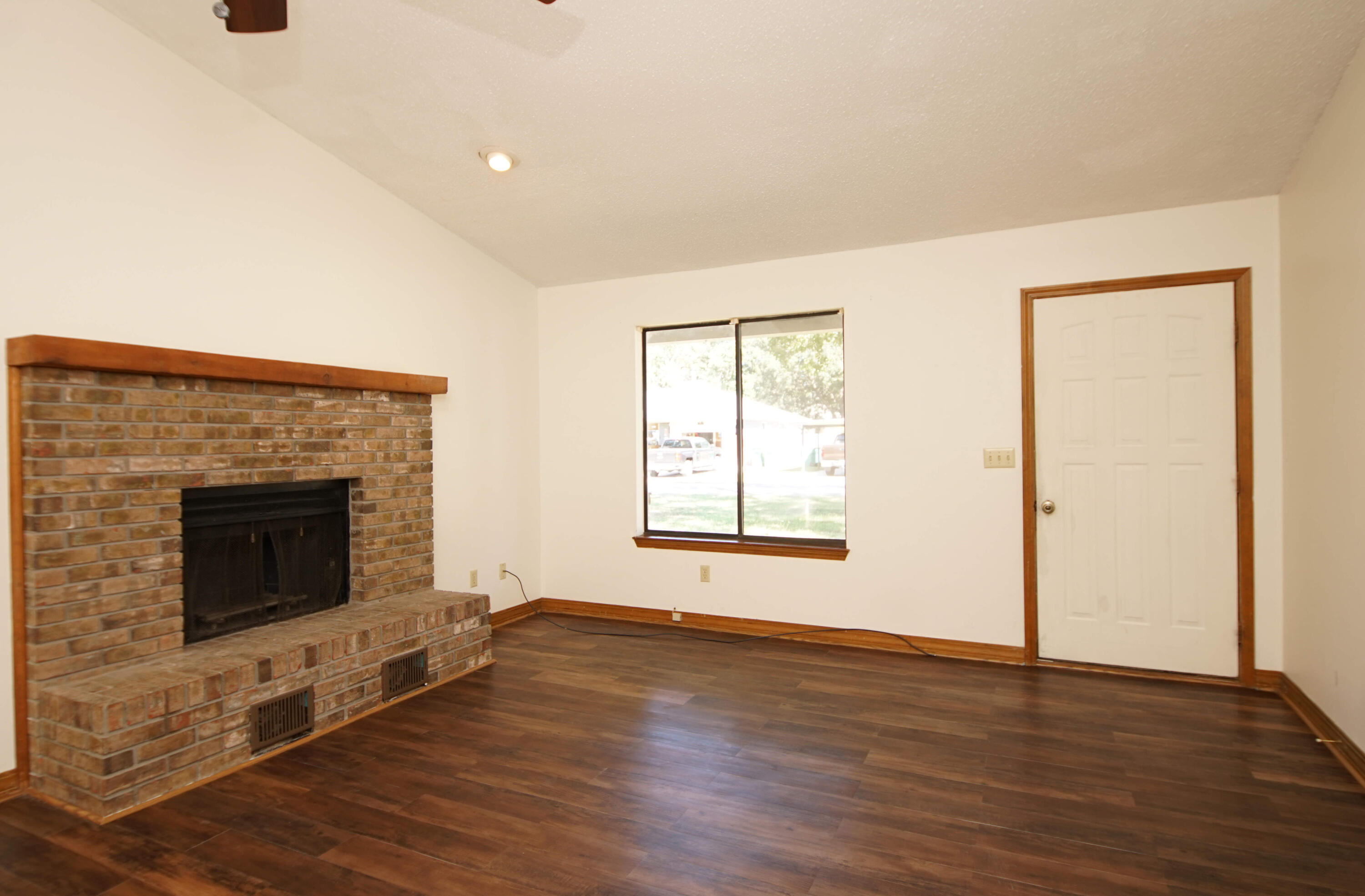 912 Nutmeg Avenue Niceville, FL 32578 - Photo 8 of 30 an empty room with wooden floor and fireplace