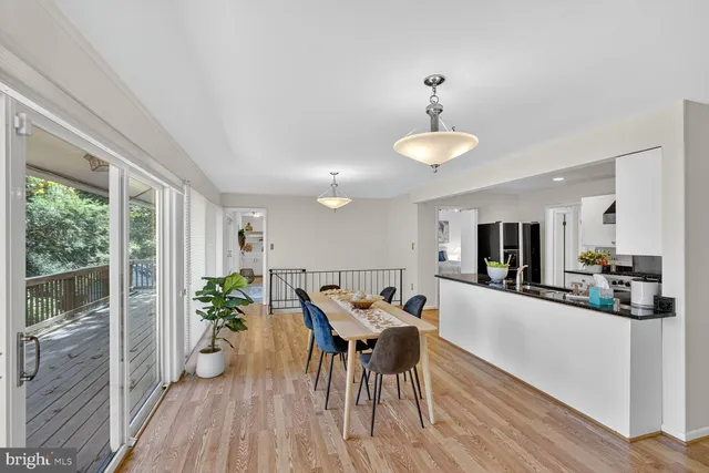 a dining room with furniture a window and wooden floor