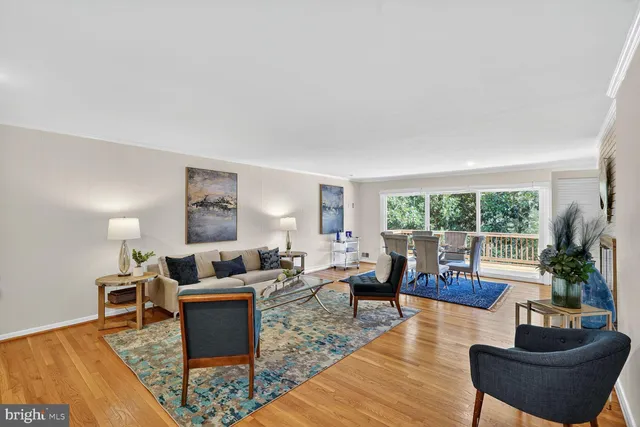 a living room with furniture large window and a table