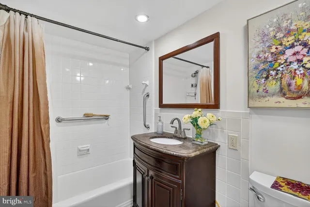 a bathroom with a sink vanity and a mirror