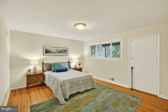 a bedroom with a bed and a night stand